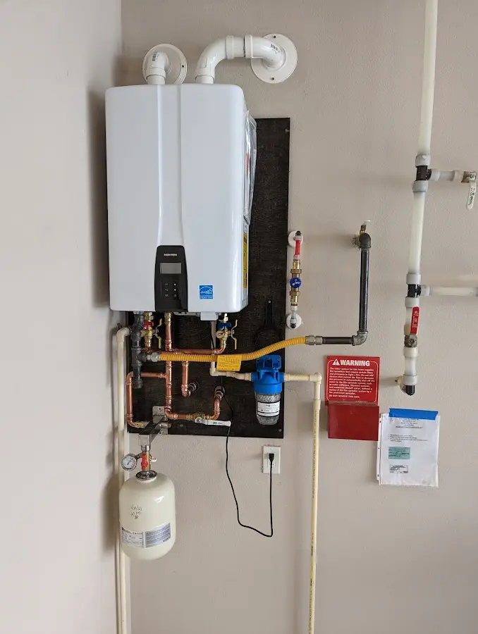 Professional plumber installing copper piping in a Hitchcock home